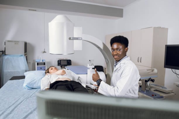 A radiation oncology specialist preparing a patient for treatment using advanced medical imaging equipment — Radiation Oncology Treatment Services.